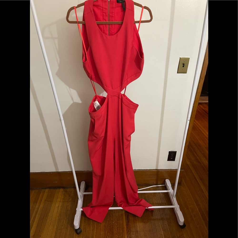 Red bcbgmaxazria size L jumpsuit with side cut outs .